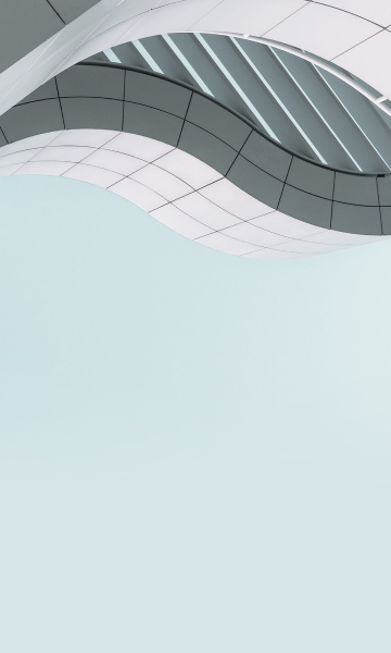 Modern building with curved facade over a clear blue sky